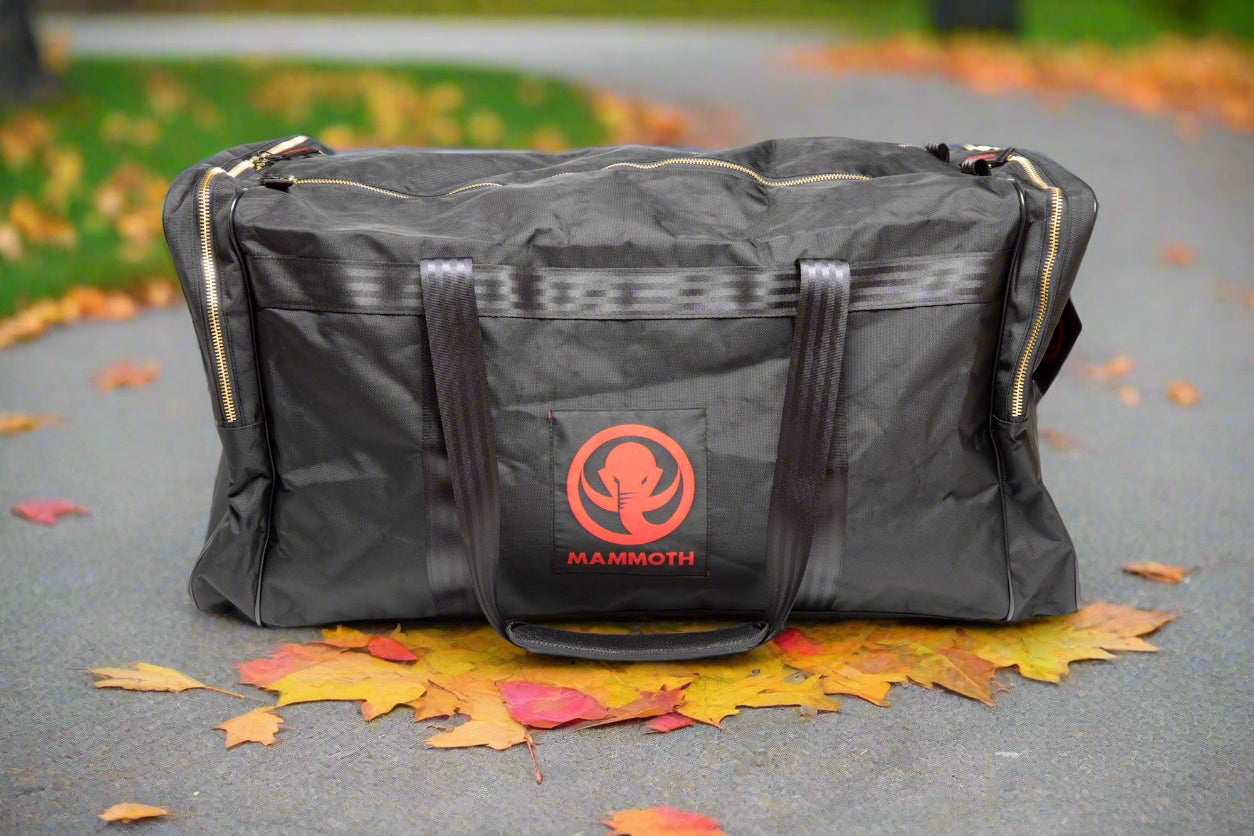 Black duffel bag with a red logo on a white background